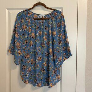 Women's blue floral print top with butterfly sleeves